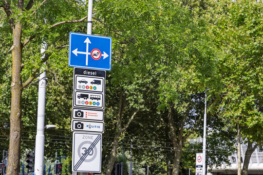 Amsterdam, Netherlands: Dutch traffic sign post displaying low emission zone diesel rules, speed limit zone, and camera enforcement in Amsterdam.