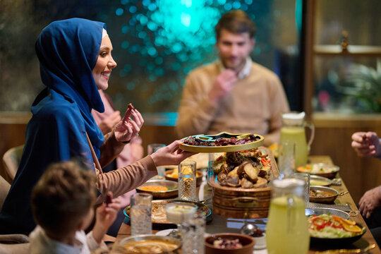 Muslim Family Sharing Iftar Dinner Together At Home During Ramadan Celebration