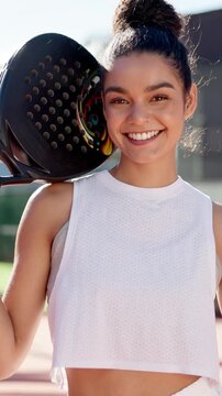 Happy woman, face and paddle tennis with confidence in fitness for sport match, game or exercise on court. Portrait, female person or athlete with smile or bat for competition, challenge or practice