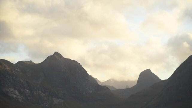 Layered mountain silhouettes over the Selfjord near Fredvang at golden hour, Lofoten, Norway