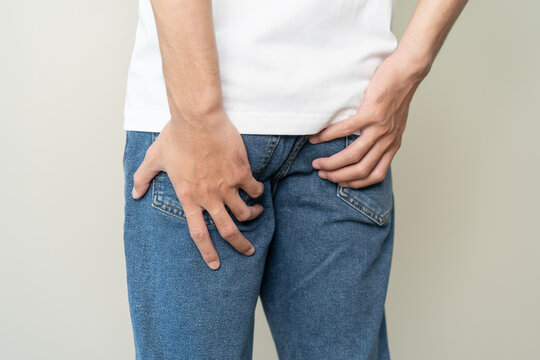 men feeling itching and scratching his crotch