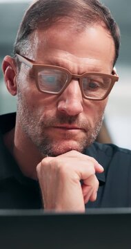 Thinking, laptop or man in office with glasses, seller insight or decision on property valuation. Reflection, tech or mature realtor with idea, mortgage plan or listing evaluation in asset investment