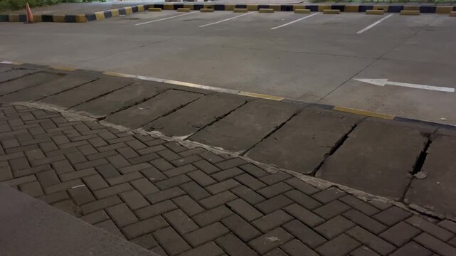 Empty Concrete Parking Lot with White Arrow Traffic Sign