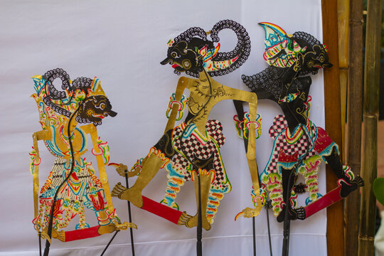Colorful traditional Indonesian Wayang Kulit shadow puppets displayed on a white background.