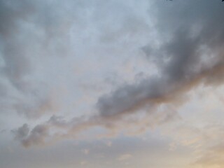 Obraz premium Storm clouds over soft sunset glow