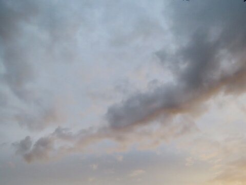 Storm clouds over soft sunset glow