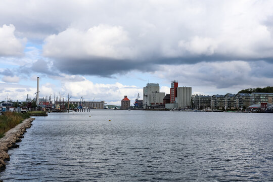 Flensburg, Germany - 17. August 2026: Industrial port city waterfront with urban buildings