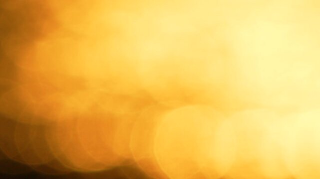 Golden bokeh glow shimmering across a textured abstract surface during twilight. Static macro lens shot captures deep warm light particles in constant motion.