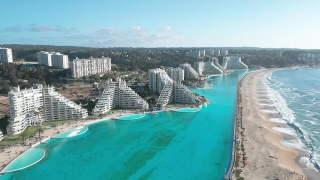 Aerial view of San Alfonso del Mar resort featuring its massive turquoise swimming pool along the sandy coastline in Algarrobo, Valparaiso, Chile.