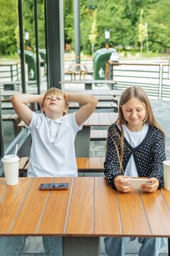 Boy Feeling Disappointed After Losing Video Game While Girl Keeps Playing