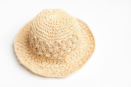 Textured straw panama hat isolated against white background creates clean product imagery. Lightweight headwear concept works for travel advertising, seasonal merchandising, and fashion content.
