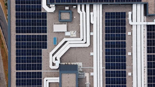 Aerial view of solar panels and HVAC ductwork on the roof of Lumen Park in Schenkon, Luzern, Switzerland.