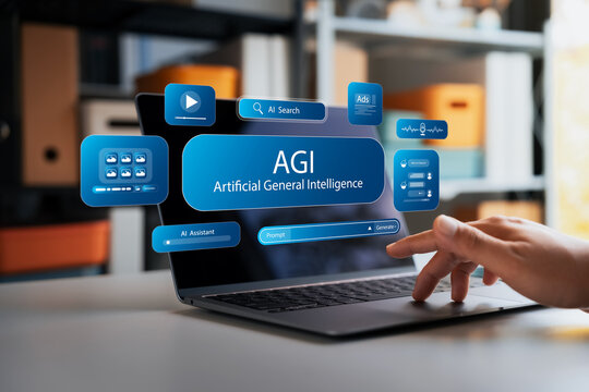 Advanced artificial general intelligence holographic interface hovers above a laptop while a person types in a workspace, highlighting smart virtual technology and modern digital innovation.