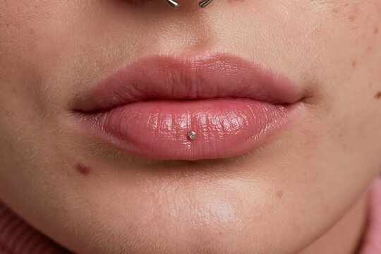 Close-up of woman's lips with labret piercing