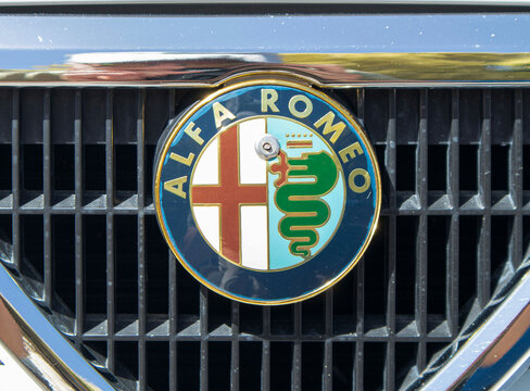 Tavernes Blanques, Spain - June 14, 2026.Close up detail of a vintage circular Alfa Romeo emblem on a black mesh front grille
