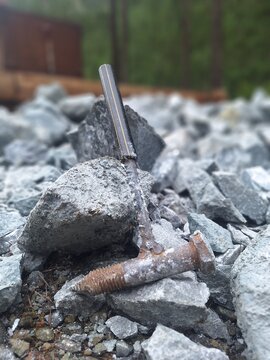 Fabricated pick hammer with broken rocks