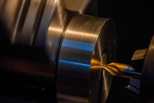 Pilot drilling process on metal shaft parts using a coated center drill tool on a lathe machine