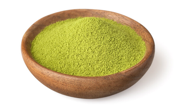 A small pile of matcha powder in the wooden plate, isolated on white background.