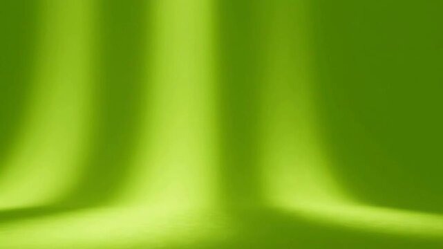Vibrant lime green studio background, with soft light, rays and smooth, gradient texture backdrop abstract