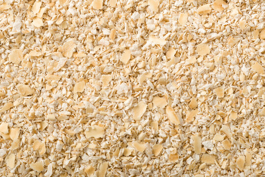 Food background of uncookded oat bran, top view.