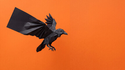 Obraz premium Origami Raven Unfolding Mid Flight, Halloween Paper Craft Object on Solid Orange Background with Copy Space