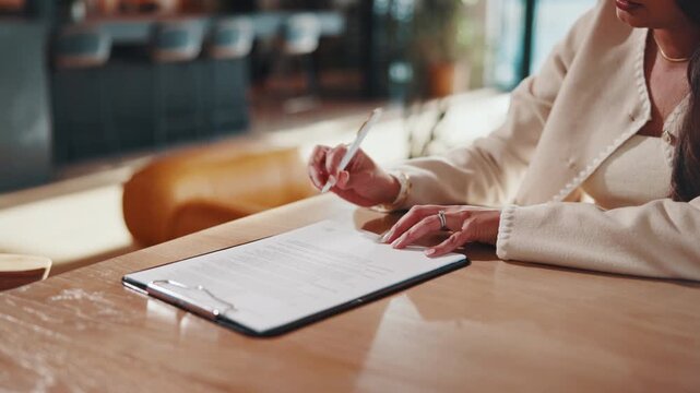 Woman, hands and signature in home with document, lease contract and form for administration. Person, sign legal paperwork or rental agreement in house with insurance policy, mortgage or loan
