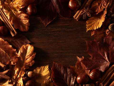 Autumn leaves and spices arranged on a wooden table for seasonal decoration