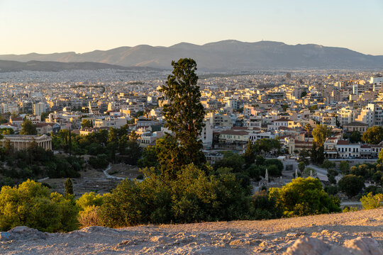 Panoramic cityscape view of Athens with Temple of Hephaestus at sunset
