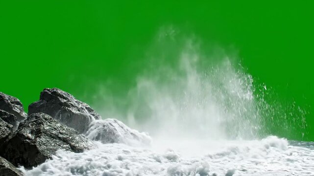 Ocean wave crashing against rocks isolated on green screen for easy compositing and vfx water splash