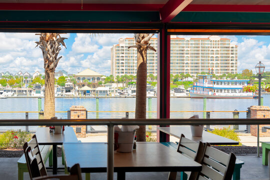 View of the marina filled with yachts and boats, a resort hotel complex, and a riverboat, from the waterfront promenade along the Intracoastal Waterway in Myrtle Beach, South Carolina.