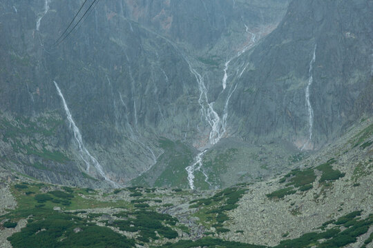 carpathians lomnicky stit peak high tatras mountains temporary waterfall after heavy rain cloudy weather atmosphere dramatic landscape nature exploration tourism concept of weather, travel, adventure,