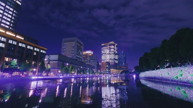 Night view of Tokyo skyline reflected in Imperial Palace moat, Japan