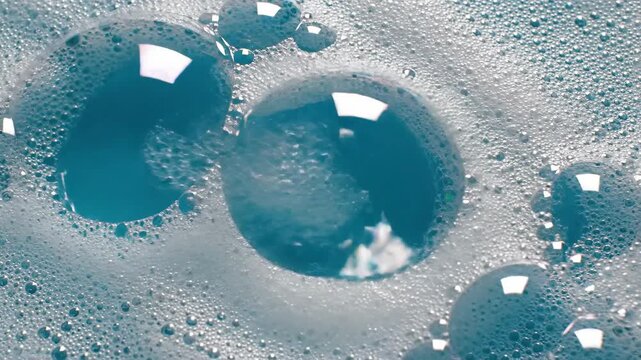 Close up of water bubbles in soapy foam texture clear blue liquids