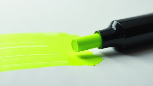 A close up shot of a yellow marker with a black tip