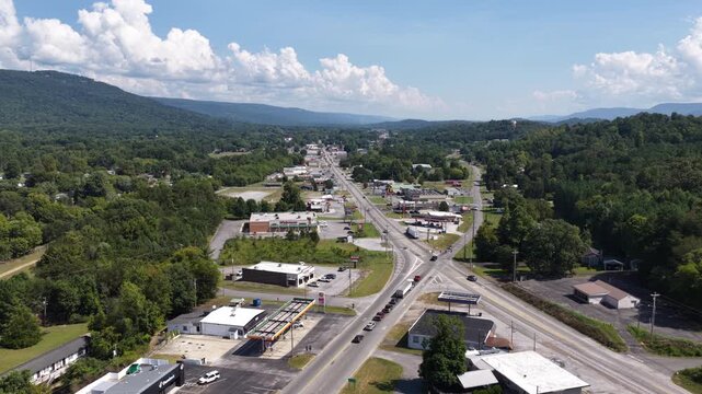 Wide aerial of small town center in Dunlap Tennessee in summer surrounded by Appalachian mountains