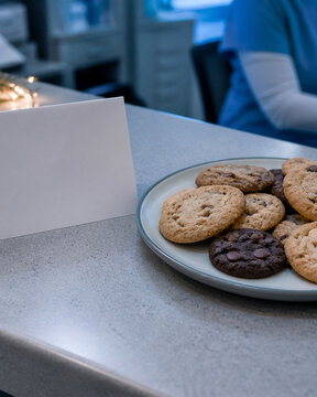 Overhead view of a plate of homemade cookies and a plain blank folded