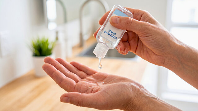 Person applying hand sanitizer gel for hygiene protection representing cleanliness routine and personal health care at home