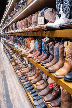 Stylish western shoes store. Choosing western shoes. Variety of fashion cowboy male boots. Fashionable footwear clothes. Fashion footwear store. Boot male fashion shop. Shopping cowboy boots