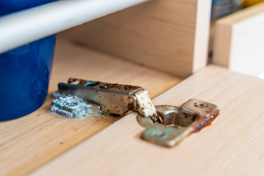 Corroded cabinet hinge inside a sailing yacht exposed to saltwater environment. Marine corrosion highlighting maintenance challenges and long term boat ownership.