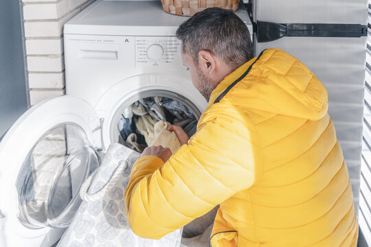 Young Man Doing Laundry at Home