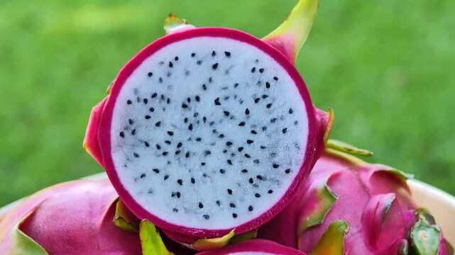 Ripe red dragon fruit placed in a bowl under natural light