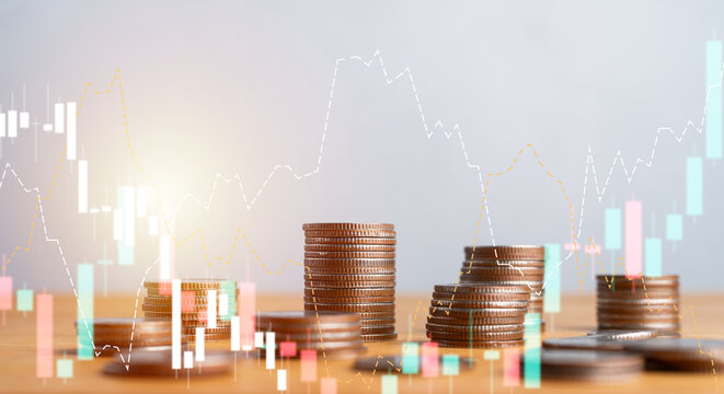 Stacks of coins with stock market graphs and candlestick charts overlay. Financial trading, investment analysis, and economic trend concept.