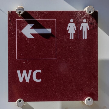 WC restroom direction sign indicating male and female facilities