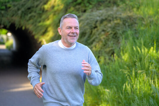 Active Senior Jogging Through Nature