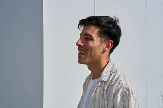 Young man laughing outdoors expressing joy and happiness
