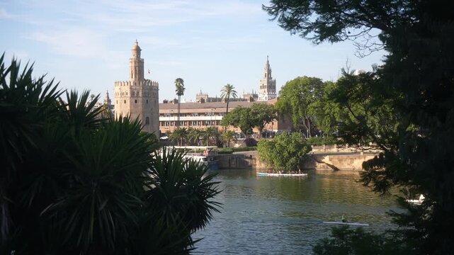 View of Canal de Alfonso XIII river and Torre del Oro (the Golden Tower) on a sunny day, Seville, Andalusia, Spain