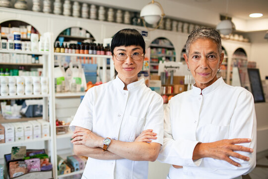 Two women pharmacists standing in a modern pharmacy