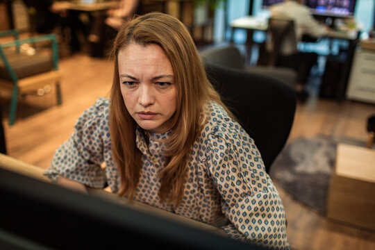 Focused businesswoman working on computer in modern office