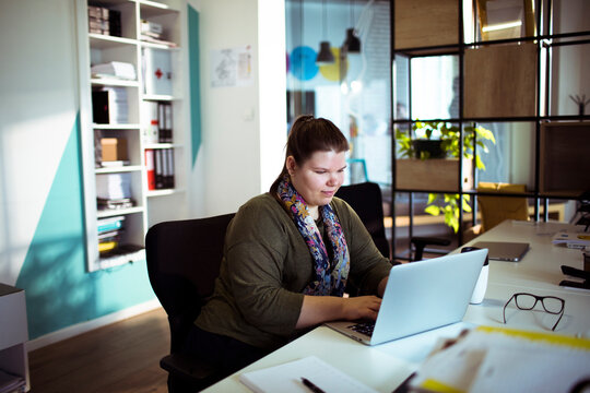Woman working on laptop in modern office