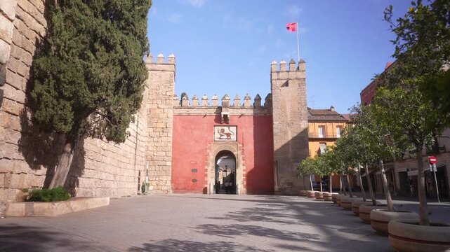 View of Puerta del Leon, entrance and external wall of Royal Alcazar of Seville on a sunny day, Sevilla, Andalusia, Spain